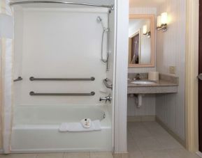 Guest bathroom with shower and tub at Hilton Garden Inn Macon / Mercer University.
