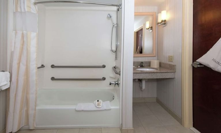 Guest bathroom with shower and tub at Hilton Garden Inn Macon / Mercer University.
