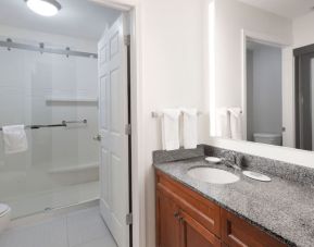 Guest bathroom with shower at Residence Inn By Marriott Bentonville Rogers.