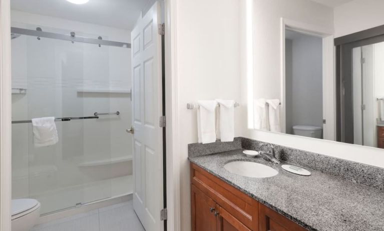 Guest bathroom with shower at Residence Inn By Marriott Bentonville Rogers.