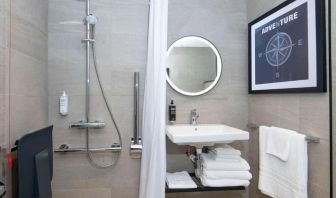 Private guest bathroom with shower at Ibis London Gatwick Airport Hotel. 