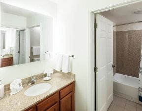 Guest bathroom with shower and tub at Residence Inn Kansas City Overland Park.