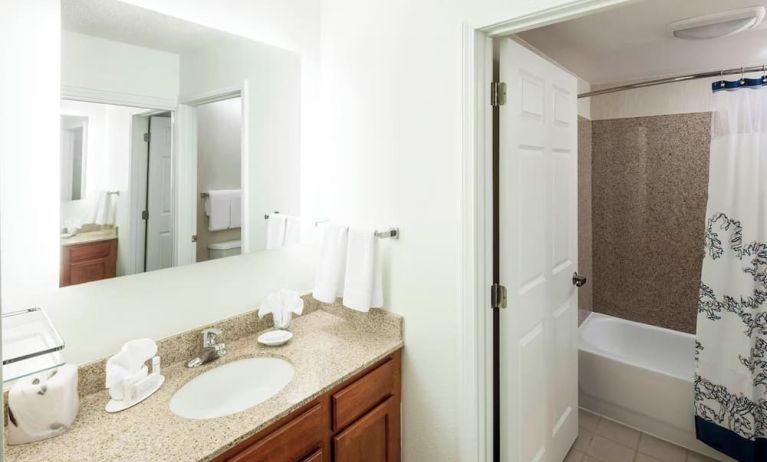 Guest bathroom with shower and tub at Residence Inn Kansas City Overland Park.