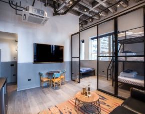 Day use room with three tier lofted bed, large living space and kitchenette at The Chicago Hotel Collection River North.