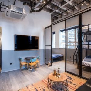 Day use room with three tier lofted bed, large living space and kitchenette at The Chicago Hotel Collection River North.