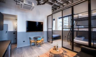 Day use room with three tier lofted bed, large living space and kitchenette at The Chicago Hotel Collection River North.