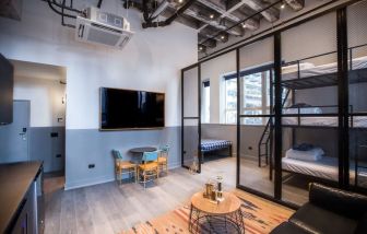 Day use room with three tier lofted bed, large living space and kitchenette at The Chicago Hotel Collection River North.