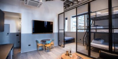 Day use room with three tier lofted bed, large living space and kitchenette at The Chicago Hotel Collection River North.