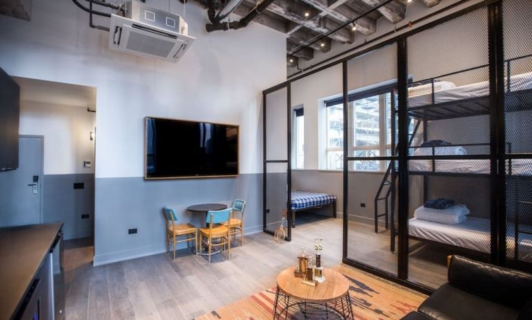 Day use room with three tier lofted bed, large living space and kitchenette at The Chicago Hotel Collection River North.