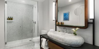 Private guest bathroom with shower at The James New York, NoMad.