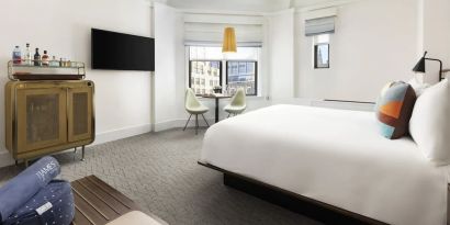 Delux king room with desk and chair at The James New York, NoMad.