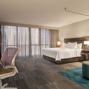 Spacious day use room with work desk and sofa at Home2 Suites By Hilton Chicago River North.
