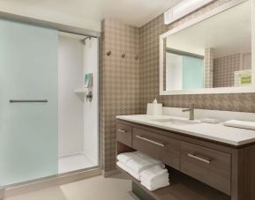 Guest bathroom with shower at Home2 Suites By Hilton Chicago River North.
