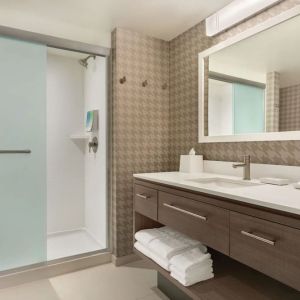 Guest bathroom with shower at Home2 Suites By Hilton Chicago River North.
