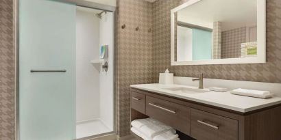 Guest bathroom with shower at Home2 Suites By Hilton Chicago River North.
