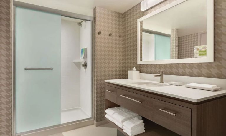 Guest bathroom with shower at Home2 Suites By Hilton Chicago River North.
