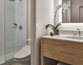 Guest bathroom with shower at Alohilani Resort Waikiki Beach.