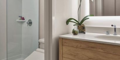 Guest bathroom with shower at Alohilani Resort Waikiki Beach.