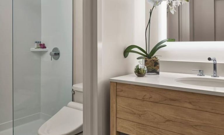 Guest bathroom with shower at Alohilani Resort Waikiki Beach.