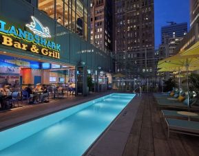 Outdoor pool at night at Margaritaville Resort Times Square.