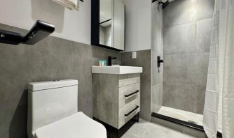 Privte guest bathroom with shower and free toiletries at Rose Hotel, Bronx.