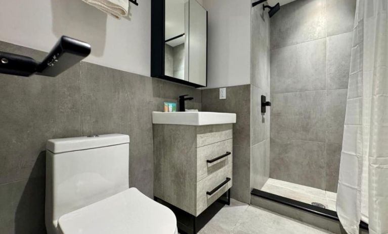 Privte guest bathroom with shower and free toiletries at Rose Hotel, Bronx.