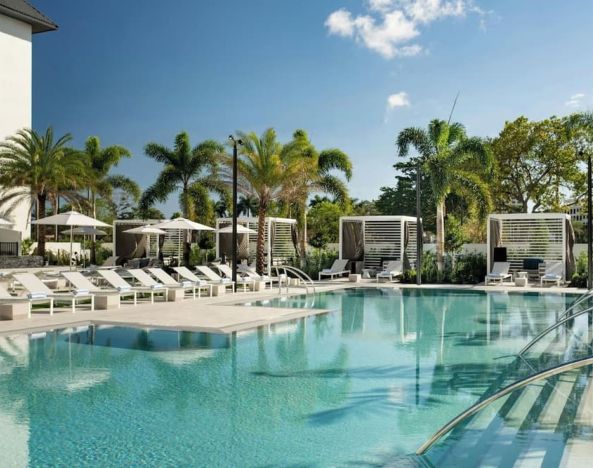 Refreshing outdoor pool surrounded by sun loungers at Renaissance Boca Raton Hotel.
