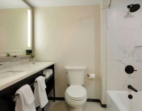 Guest bathroom with shower and tub at Renaissance Boca Raton Hotel.
