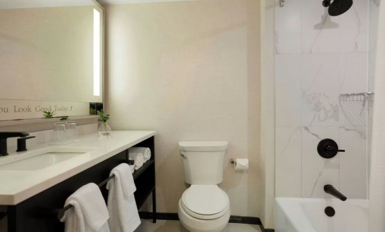 Guest bathroom with shower and tub at Renaissance Boca Raton Hotel.
