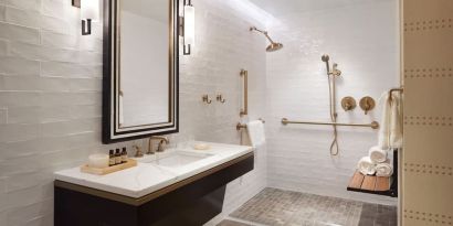 Guest bathroom with shower at The Plaza Pioneer Park, El Paso.