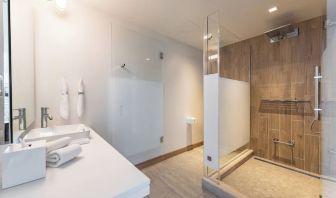 Guest bathroom with shower at The Envoy Hotel, Autograph Collection.