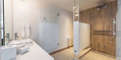 Guest bathroom with shower at The Envoy Hotel, Autograph Collection.