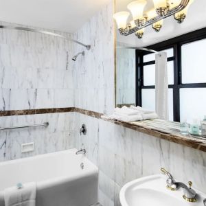 Guest bathroom with shower at The New Yorker Hotel, A Wyndham Hotel.