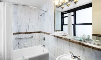 Guest bathroom with shower at The New Yorker Hotel, A Wyndham Hotel.