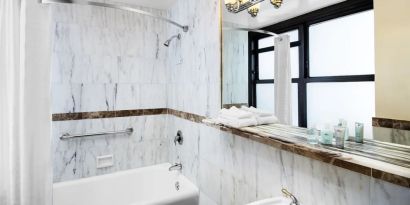 Guest bathroom with shower at The New Yorker Hotel, A Wyndham Hotel.