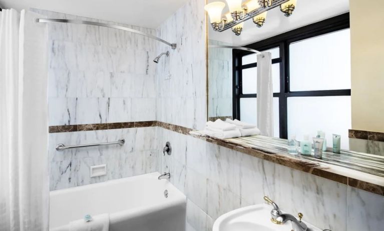 Guest bathroom with shower at The New Yorker Hotel, A Wyndham Hotel.