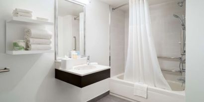 Guest bathroom with shower and tub at Hampton Inn Philadelphia Center City - Convention Center.