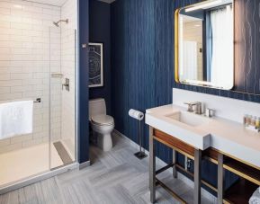 Private guest bathroom with shower at Rand Tower Hotel, Minneapolis, A Marriott Tribute Portfolio Hotel.