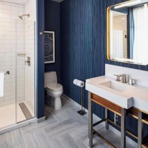 Private guest bathroom with shower at Rand Tower Hotel, Minneapolis, A Marriott Tribute Portfolio Hotel.