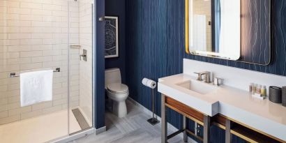 Private guest bathroom with shower at Rand Tower Hotel, Minneapolis, A Marriott Tribute Portfolio Hotel.