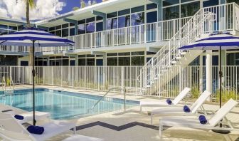 Refreshing outdoor pool and sun loungers at Plunge Beach Resort.