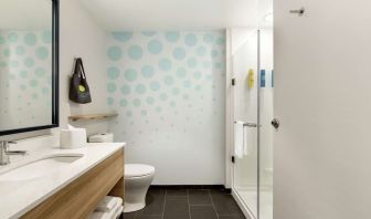 Guest bathroom with shower at Tru By Hilton Wichita Northeast.
