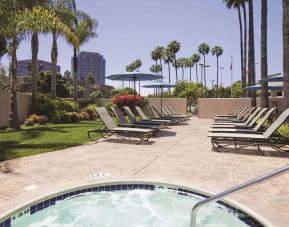 Outdoor pool with lounge chairs at Embassy Suites By Hilton San Diego-La Jolla.