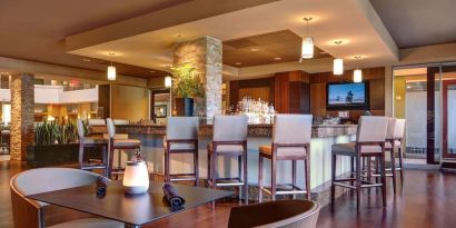 Hotel bar with lounge seating at Embassy Suites By Hilton San Diego-La Jolla.