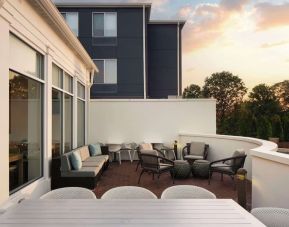 Outdoor terrace with lounge seating at Hilton Garden Inn Kennett Square.