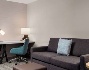 Day use room with workspace and lounge seating at Hilton Garden Inn Kennett Square.