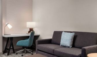 Day use room with workspace and lounge seating at Hilton Garden Inn Kennett Square.