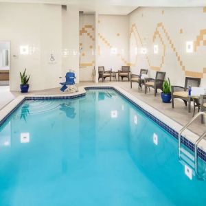 Indoor pool with lounge chairs at Hilton Garden Inn Washington DC Downtown.