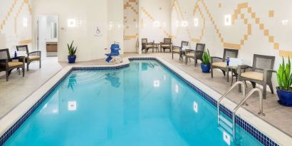 Indoor pool with lounge chairs at Hilton Garden Inn Washington DC Downtown.