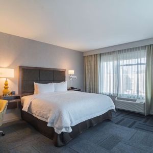 King bed with work desk at Hampton Inn Chicago North/Loyola Station.